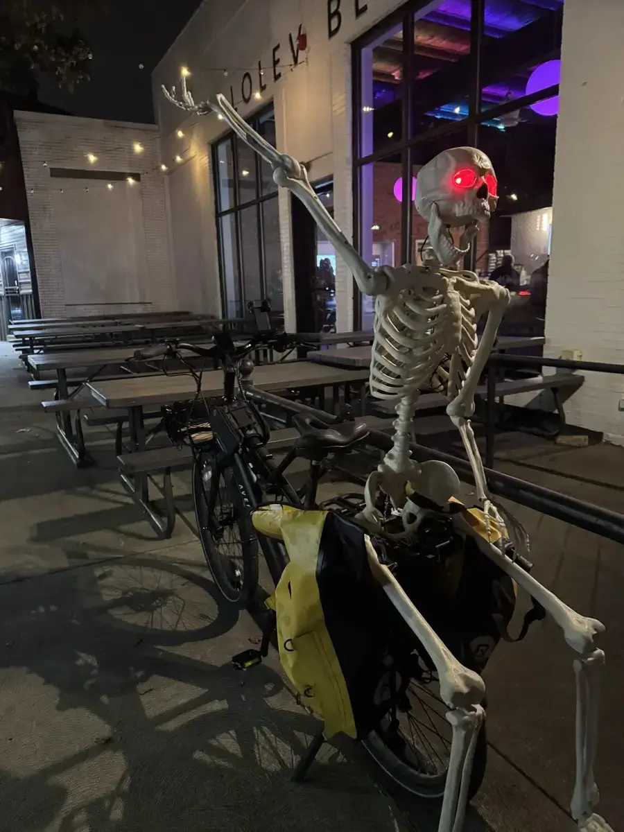 Skeleton on cargo bike with glowing red eyes